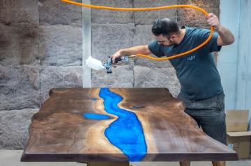 Applying Finish to Table in Spray Booth