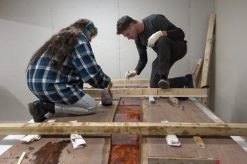 Sky and Zach Swirling Resin in Epoxy Pour Room